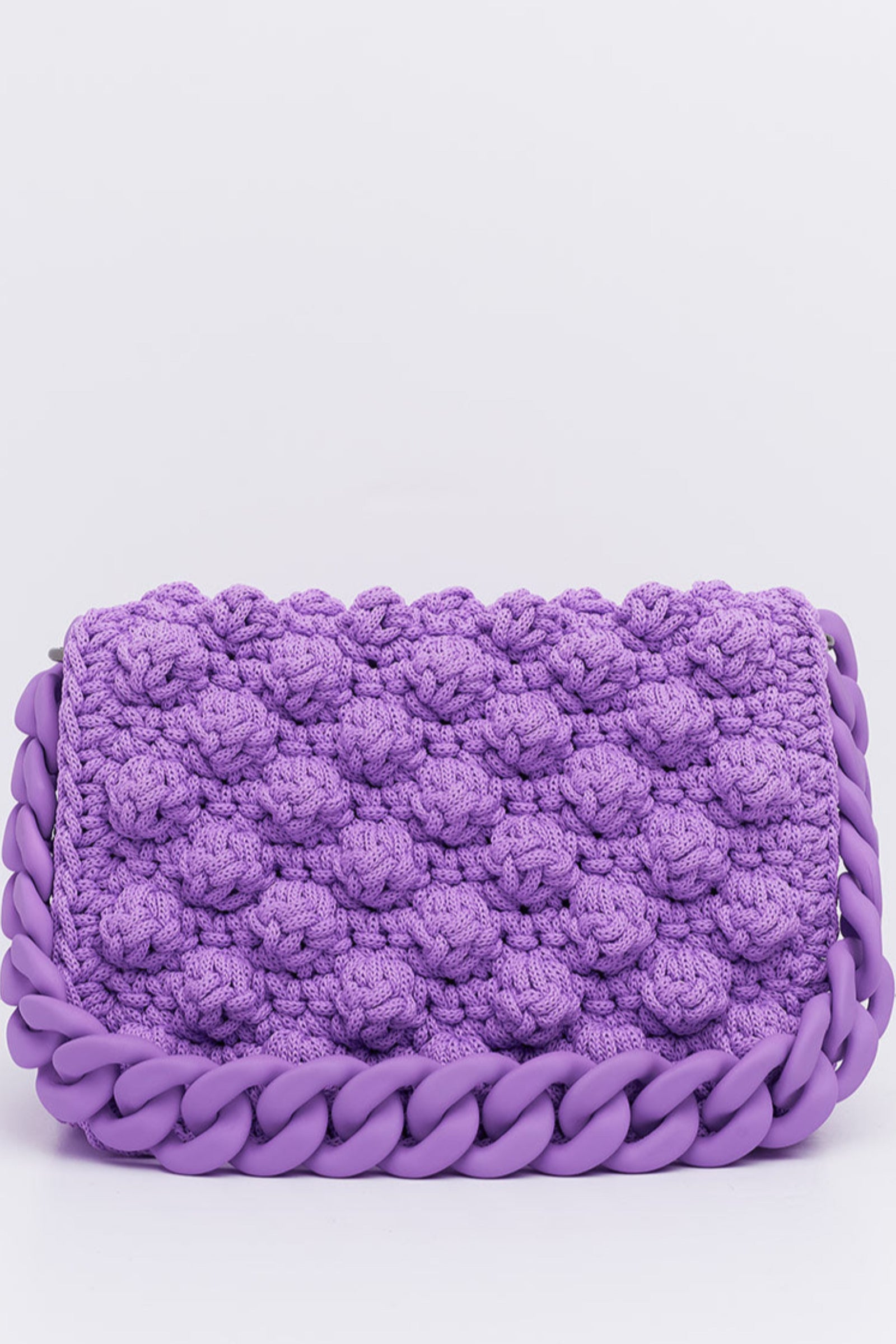A hand made crochet bag in lilac color with a silicon chain, part of the '90s Collection'. The bag features a textured bubble pattern.