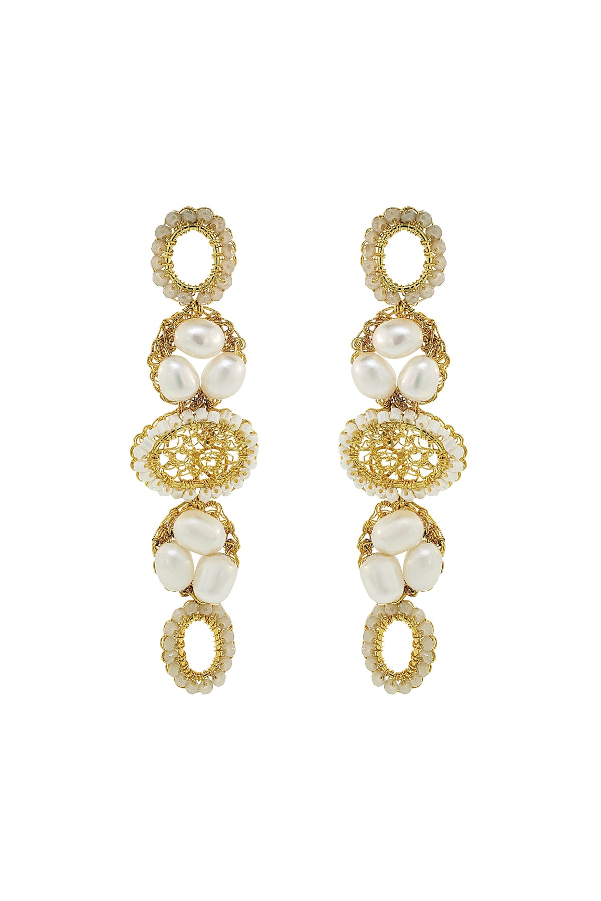 Gold and pearl earrings on a white background