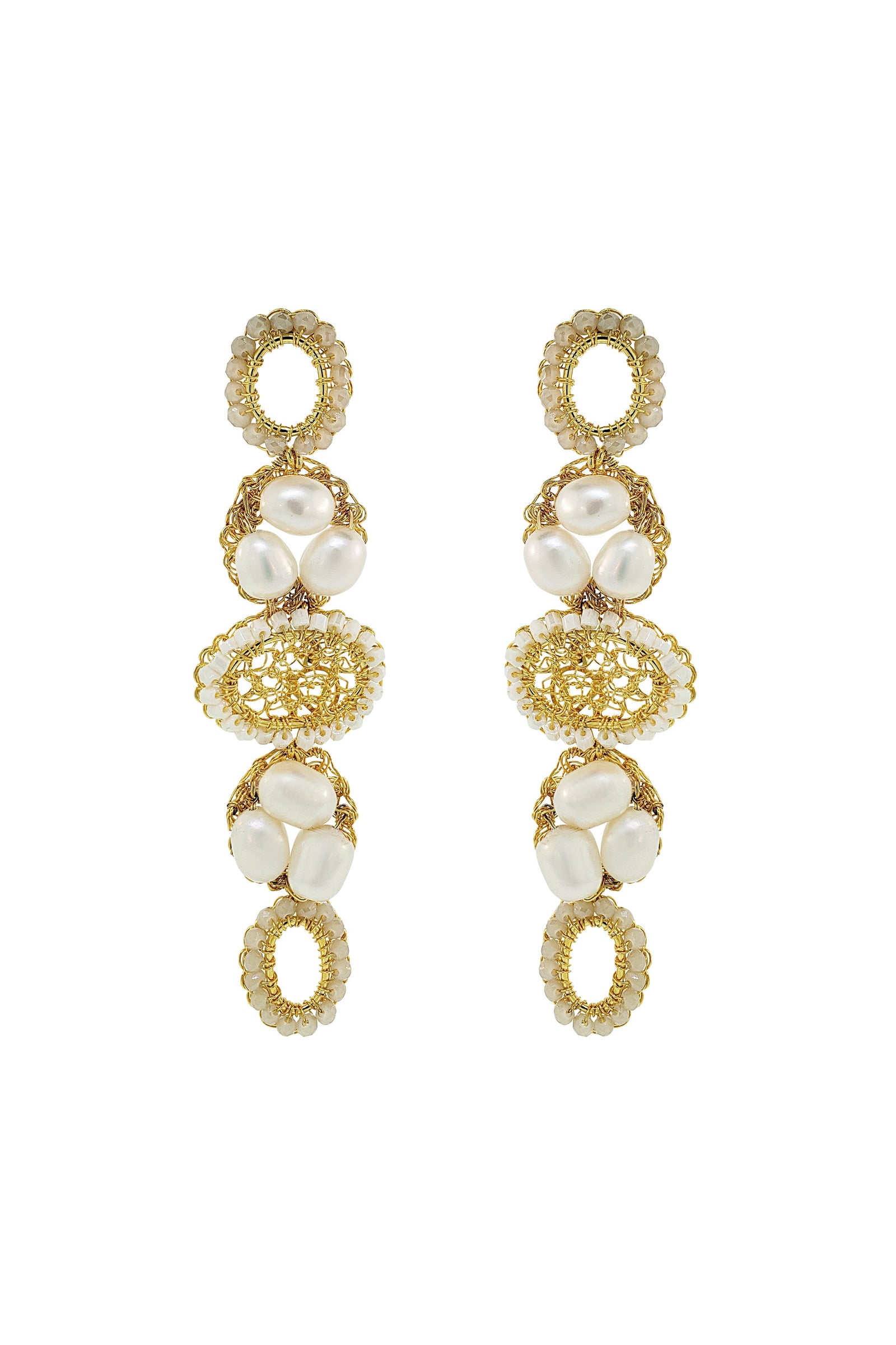 Gold and pearl earrings on a white background