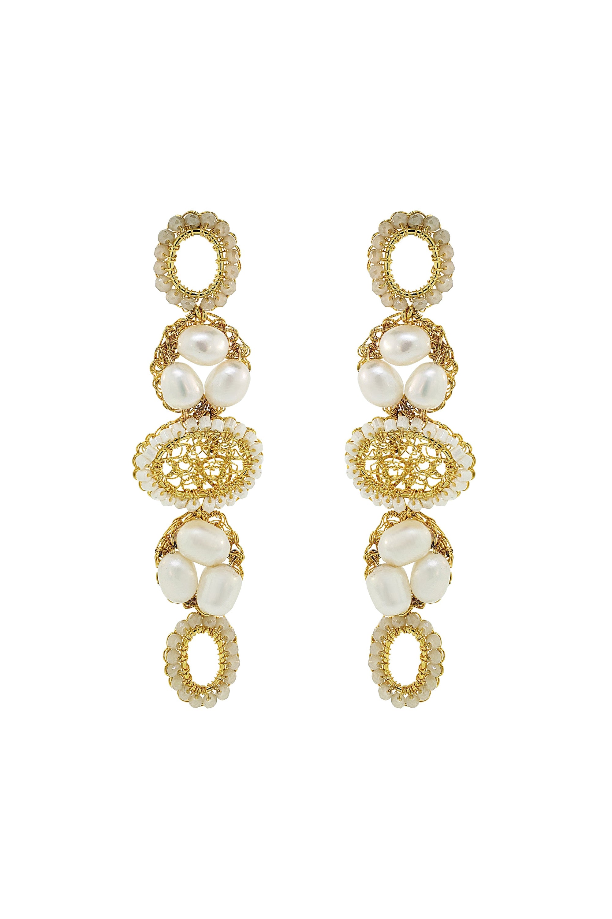 Gold and pearl earrings on a white background