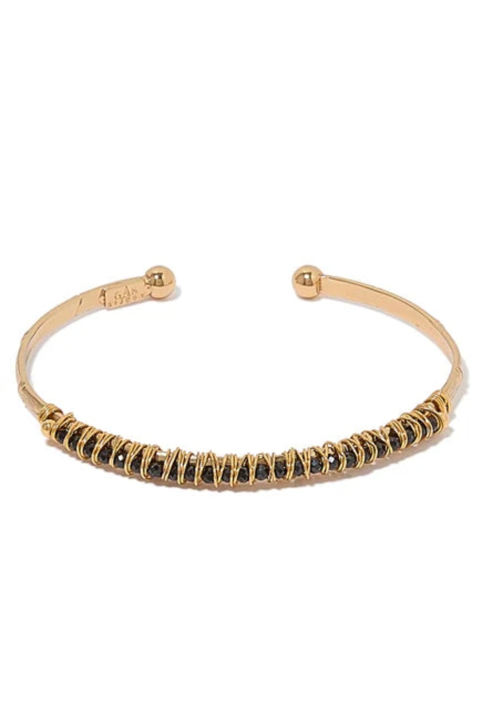 Gold bracelet with black stones on a white background