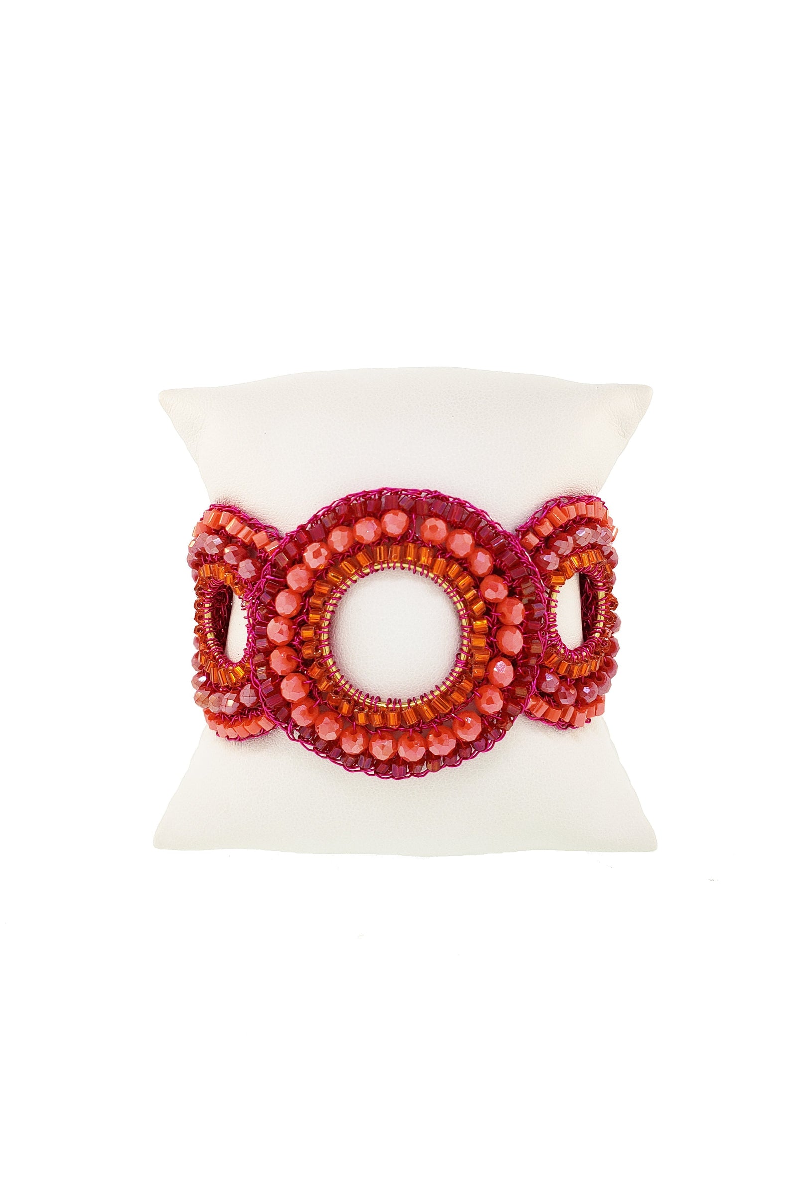 Red beaded bracelet with gold clasp on a white background