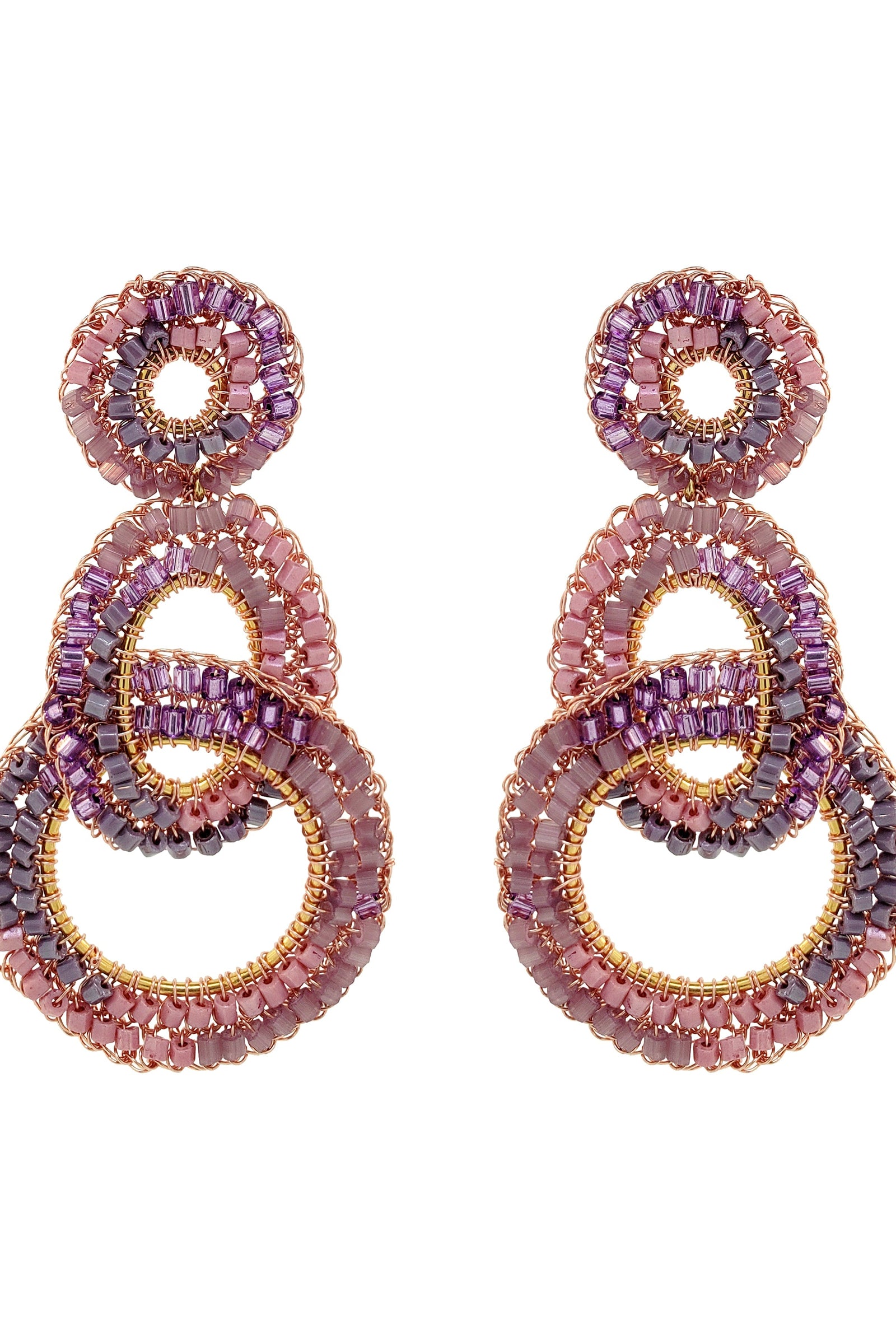 Pair of pink and purple beaded earrings on a white background