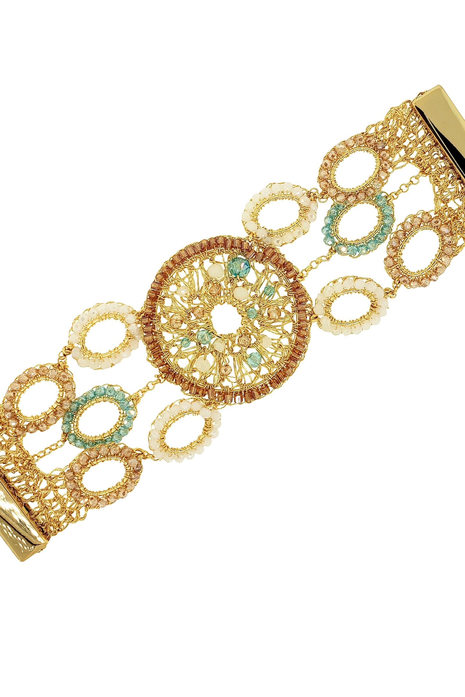 Gold bracelet with intricate design and green gemstones on a white background
