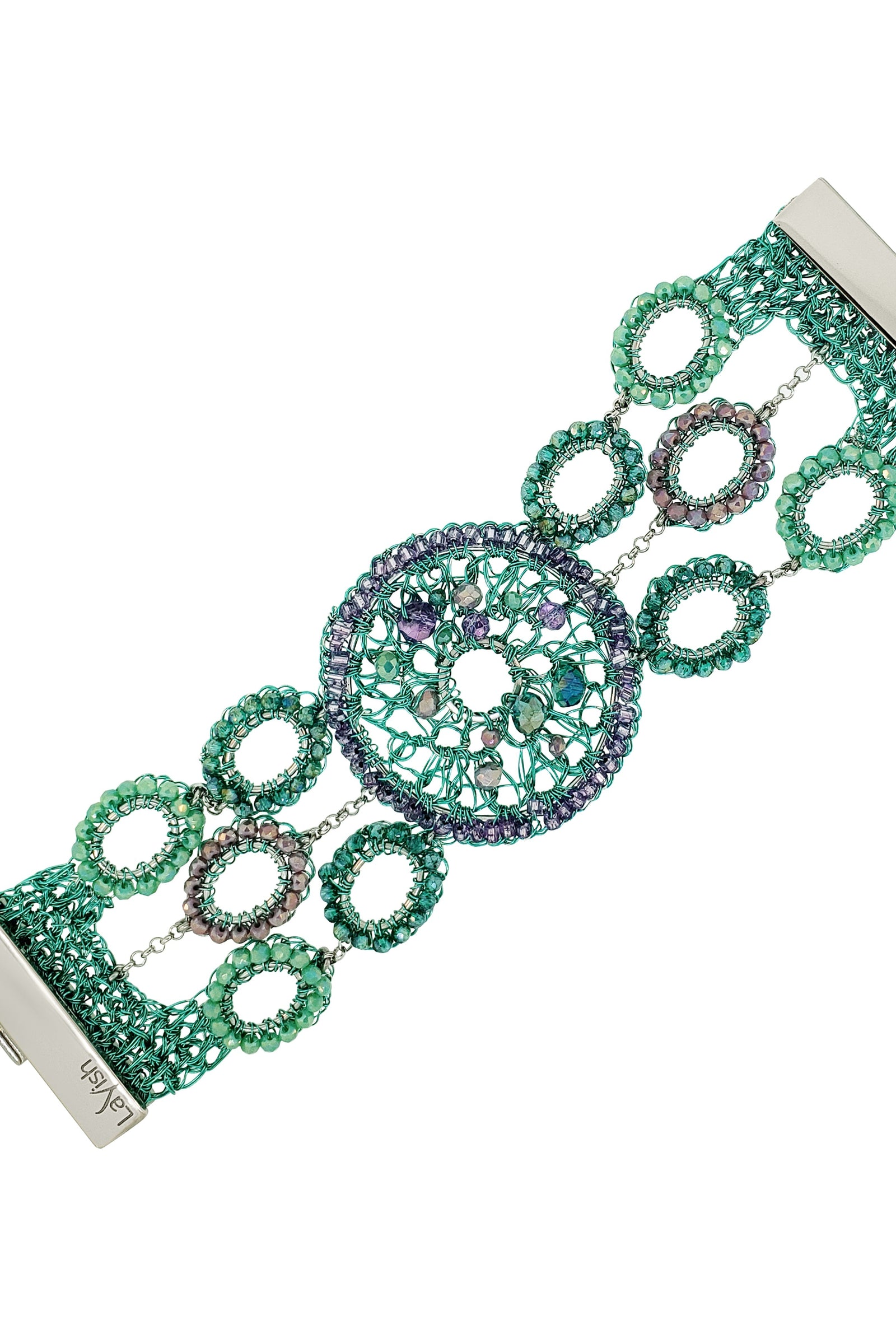 Decorative bracelet with green and silver design on a white background