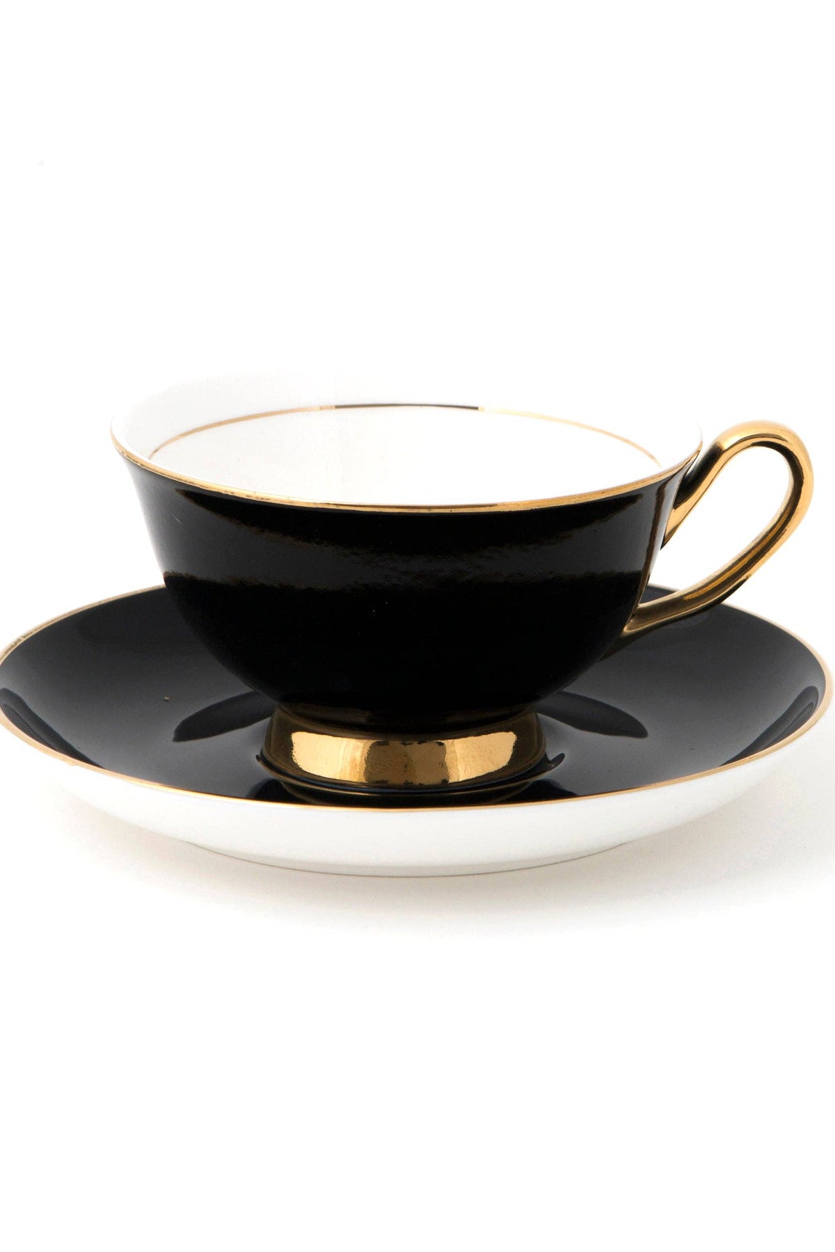 Black teacup and saucer with gold trim on a white background