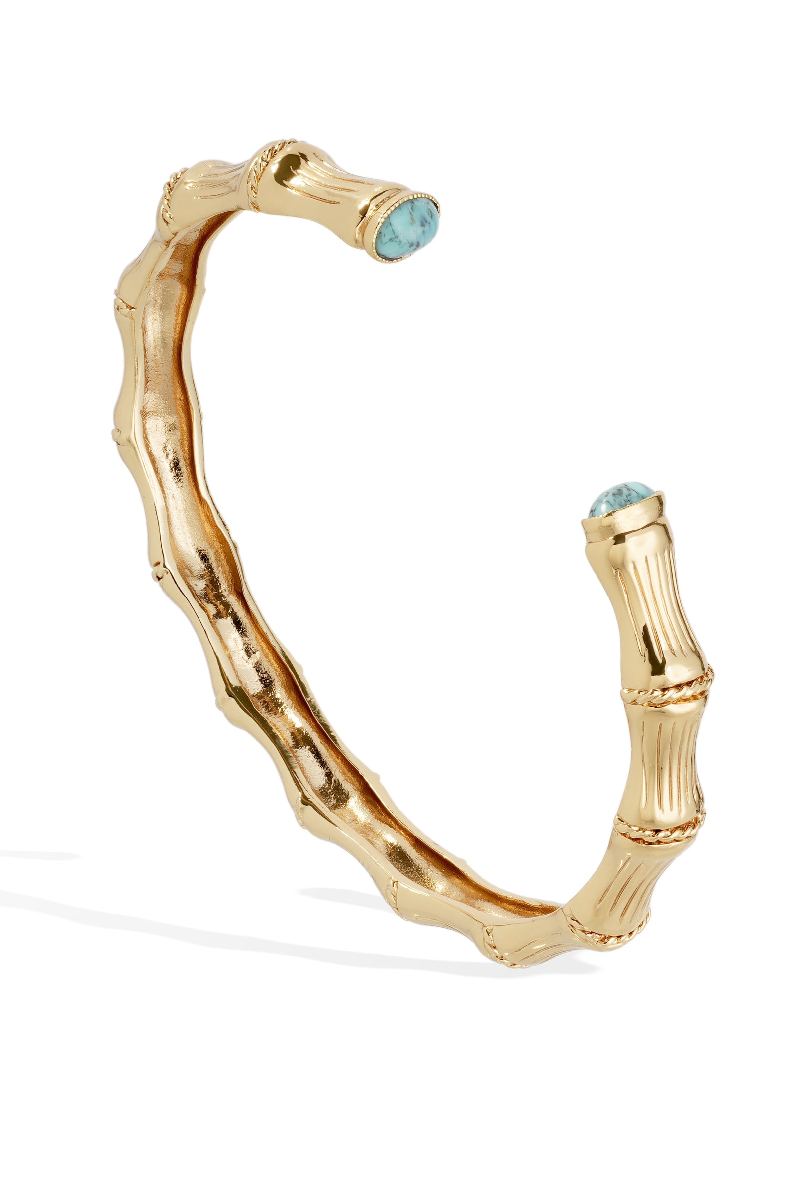 Gold bracelet with turquoise stones on a white background