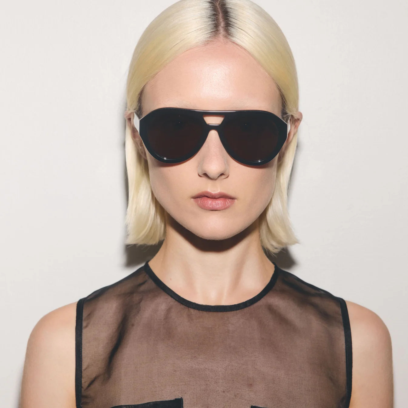 Black sunglasses with brown lenses on a white background
