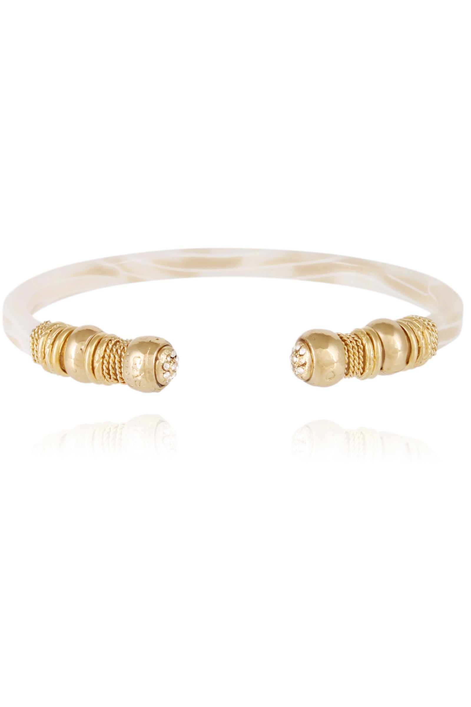 A gold-colored bracelet with a patterned strap and decorative elements, featuring small green gemstones.