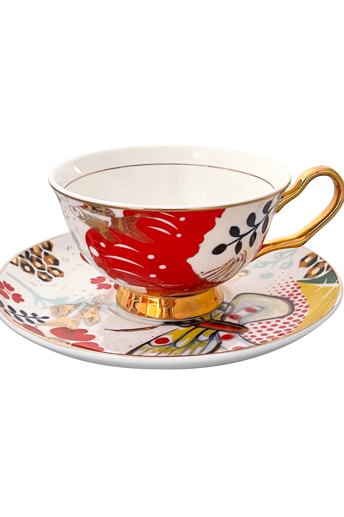 A teacup and saucer with a colorful design featuring butterflies, flowers, and gold accents on a white background.