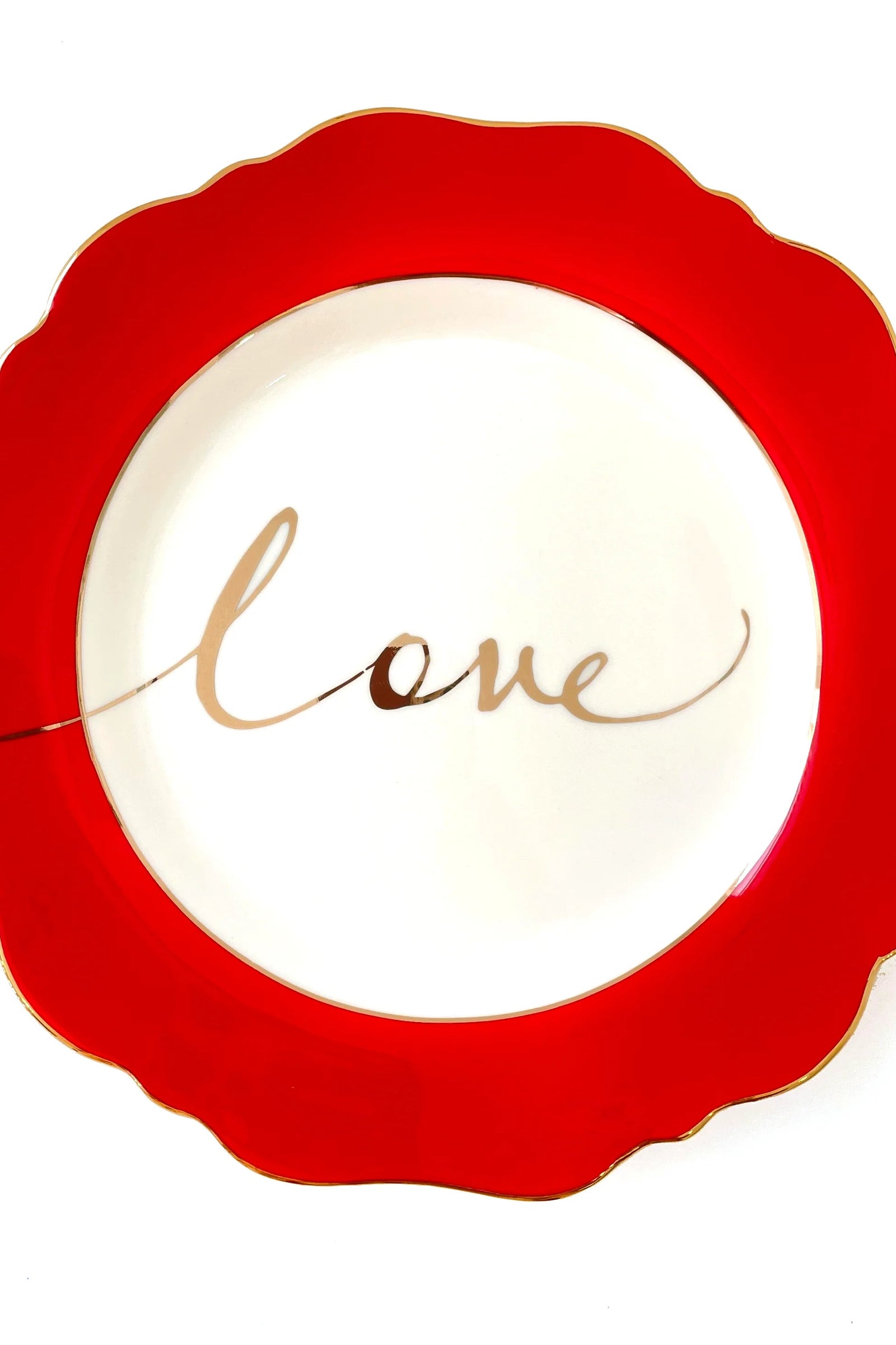 A red side plate with the word 'love' written in cursive gold calligraphy in the center.