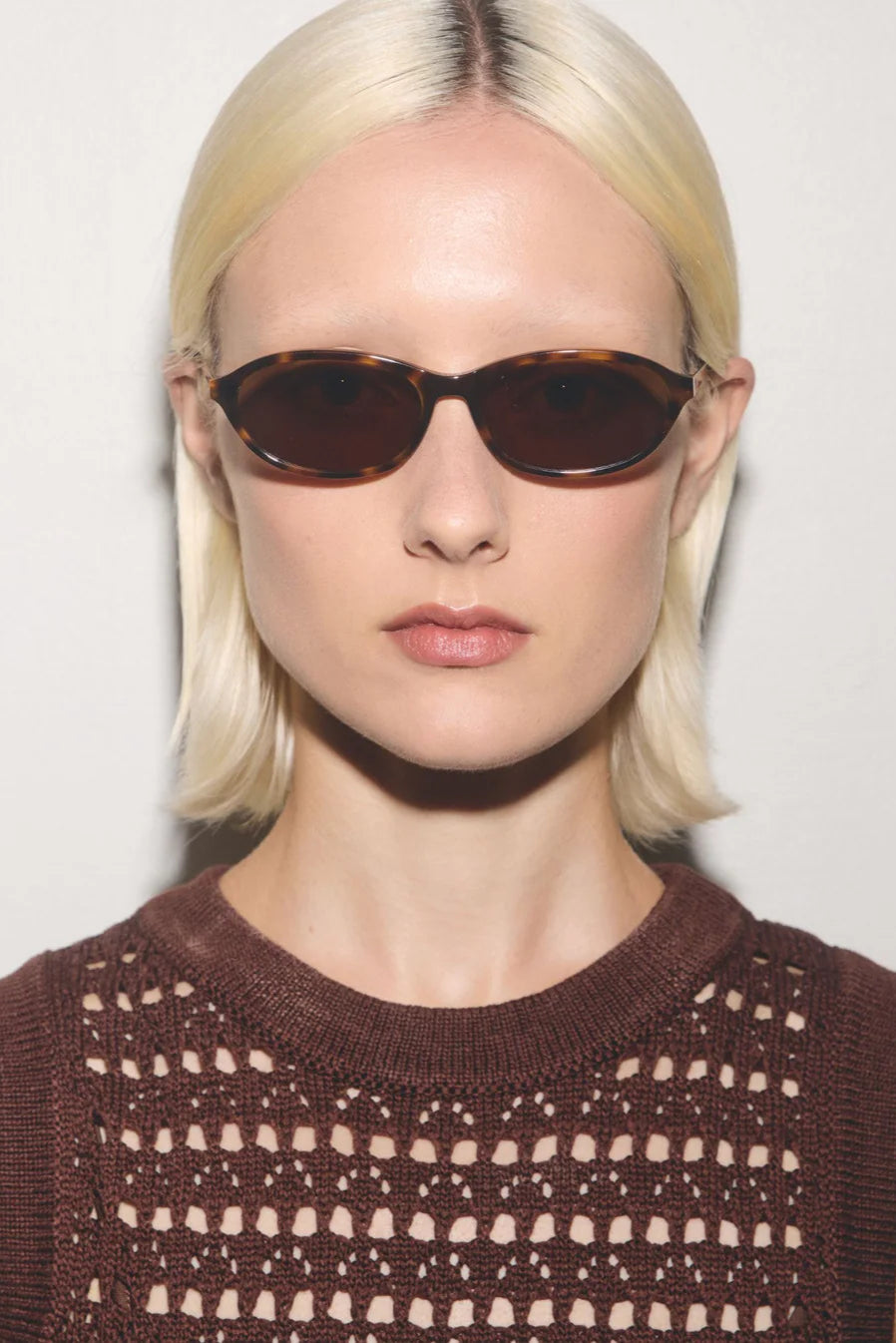 Sunglasses with tortoiseshell frame and brown lenses on a white background