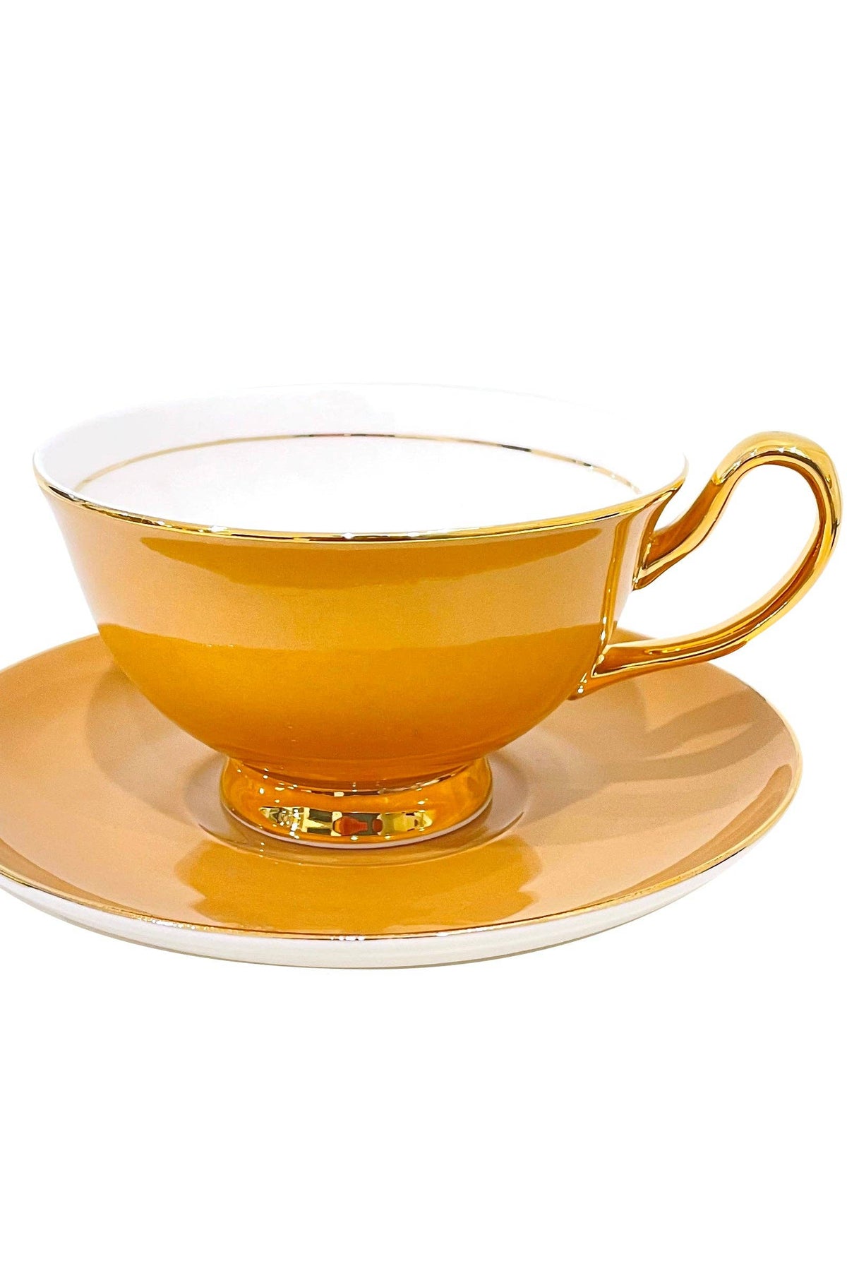 Orange teacup and saucer with gold accents on a white background