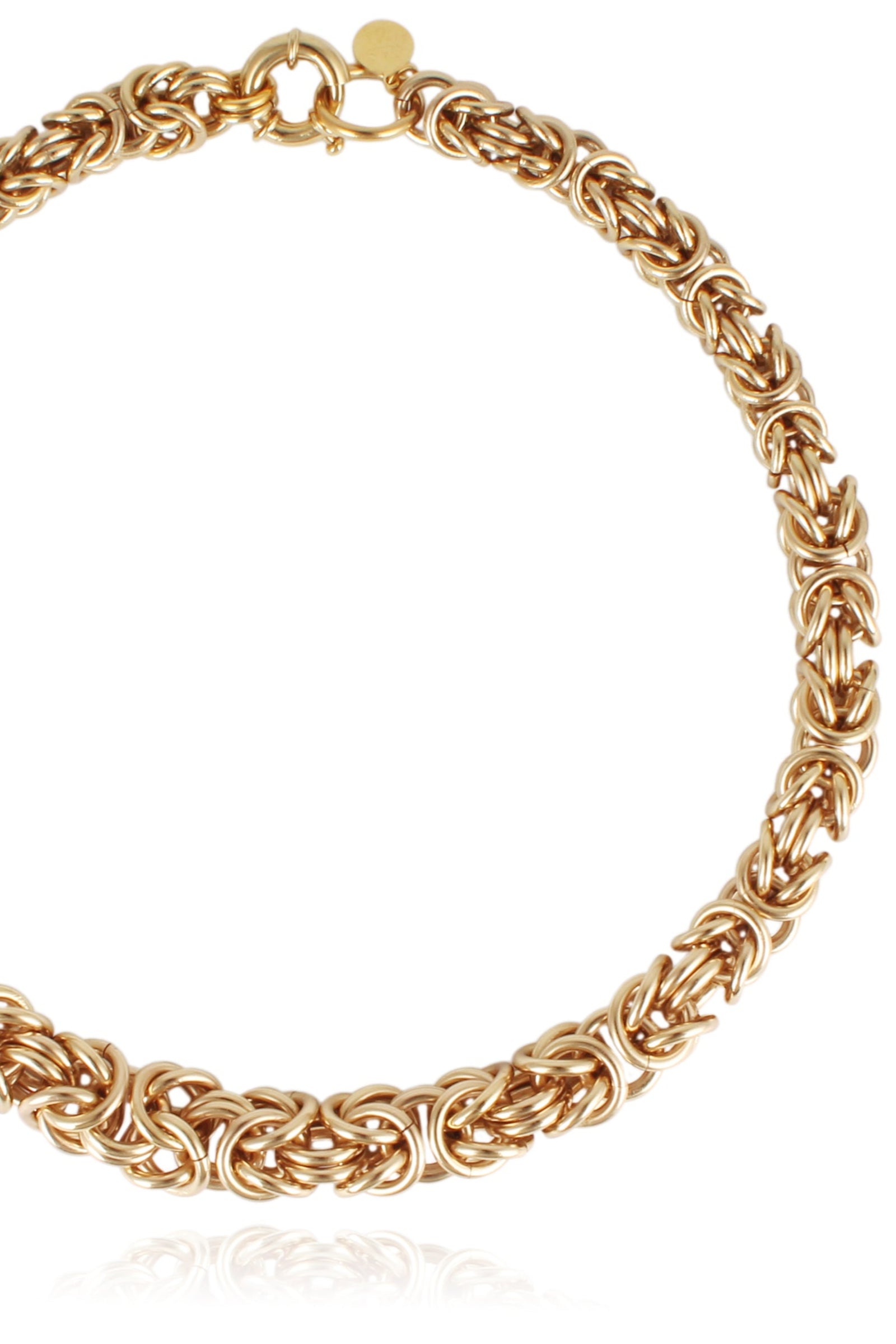 This image displays the Claude O Necklace, featuring an intricate and elegant gold-tone chain. The necklace is designed with a robust and textured link chain that enhances its luxurious appeal.