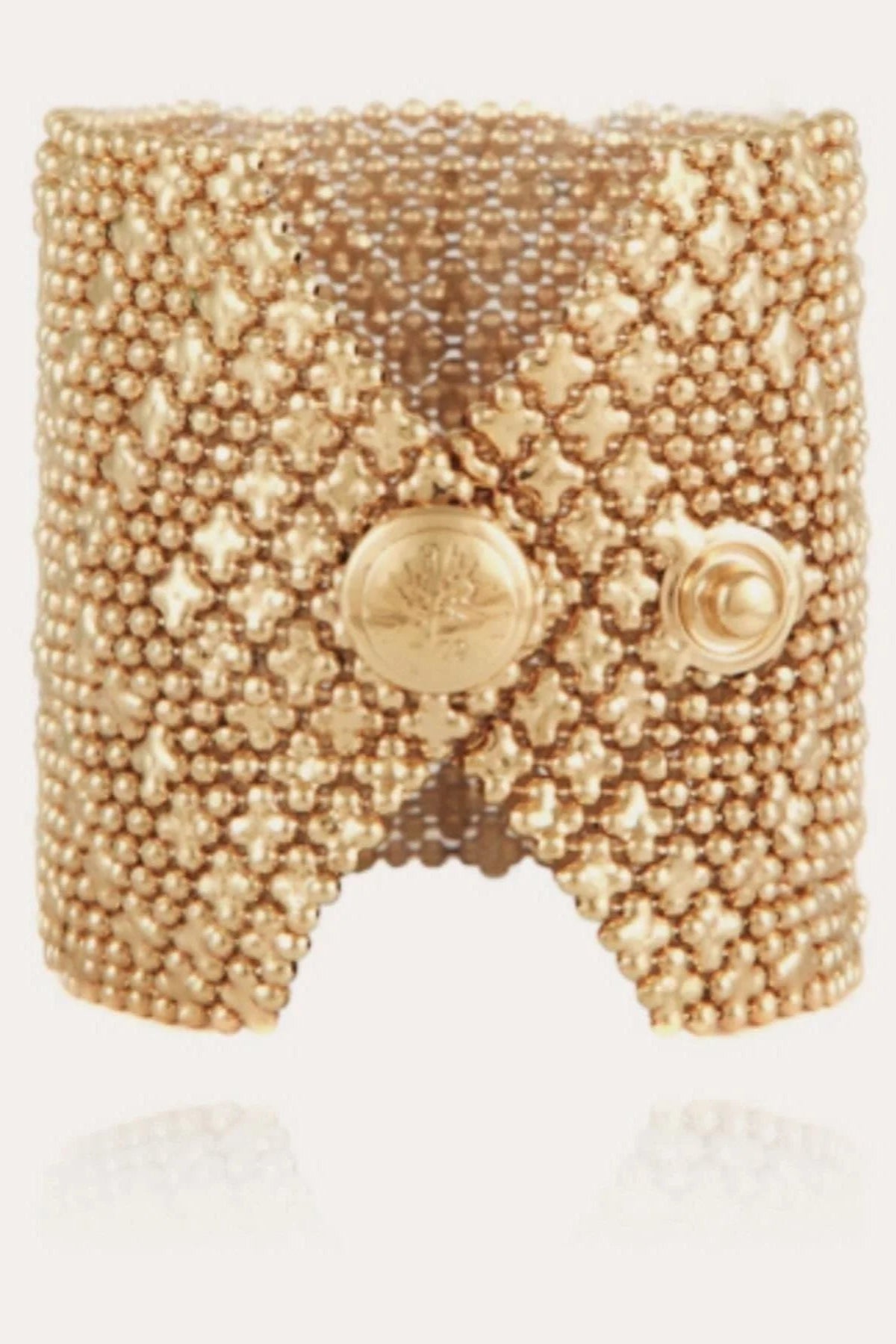 A gold-plated bracelet with a geometric pattern of linked ball chains and star motifs.