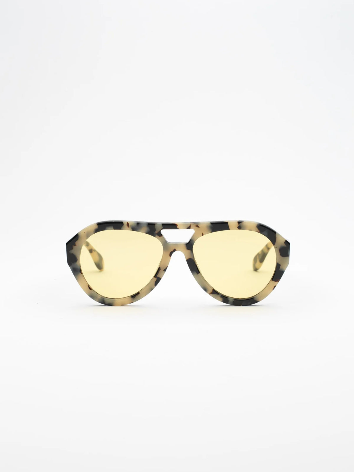 Sunglasses with tortoiseshell frame and yellow lenses on a white background