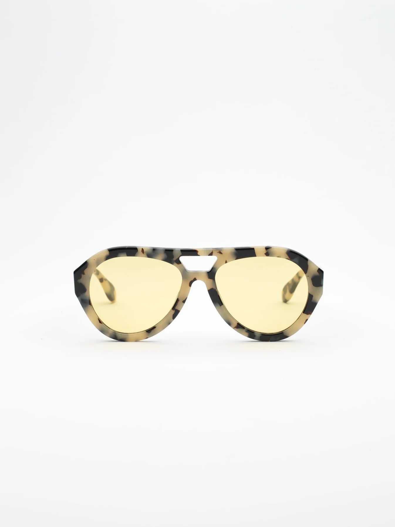 Sunglasses with tortoiseshell frame and yellow lenses on a white background