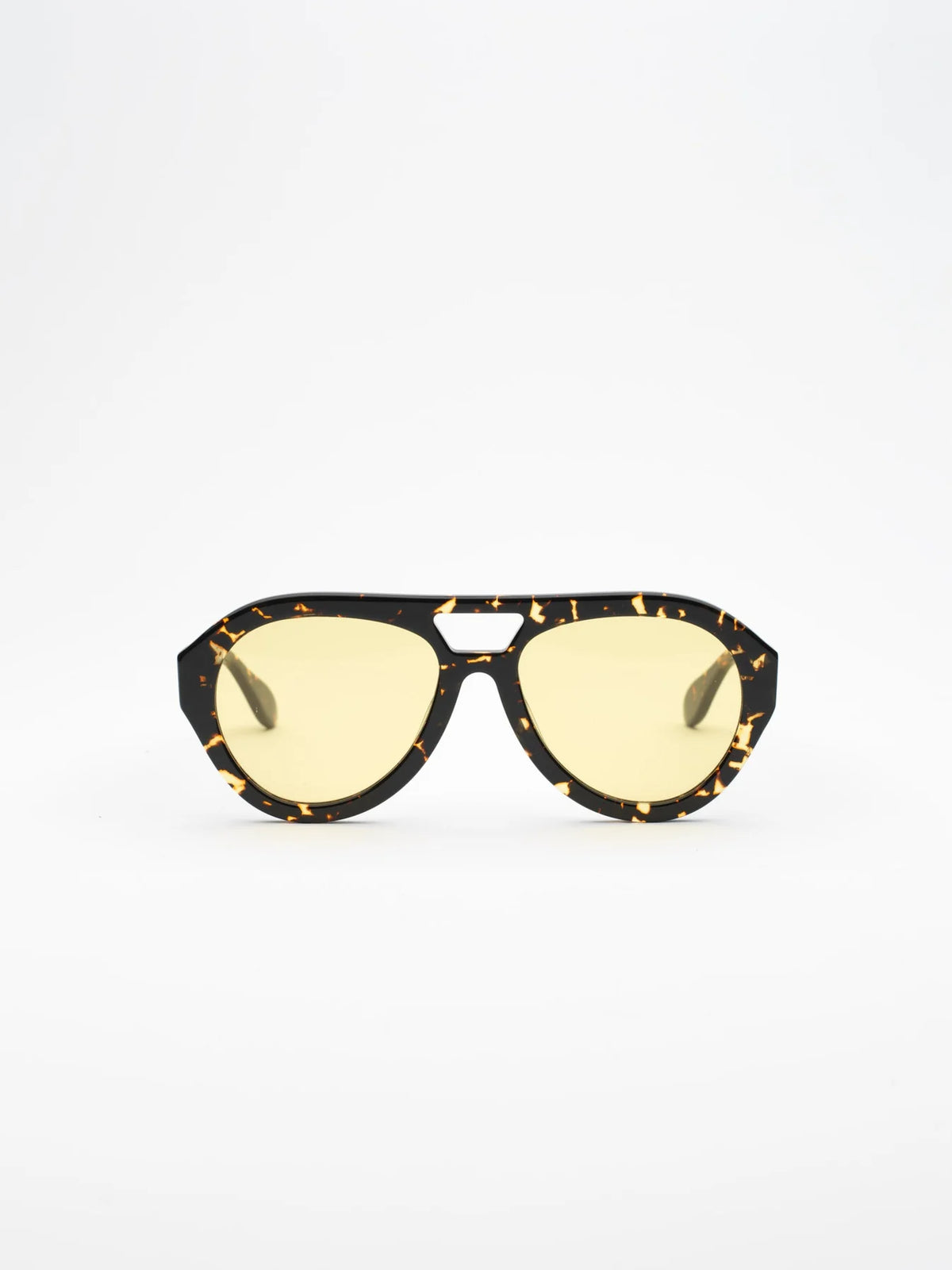 Sunglasses with tortoiseshell frame and yellow lenses on a white background