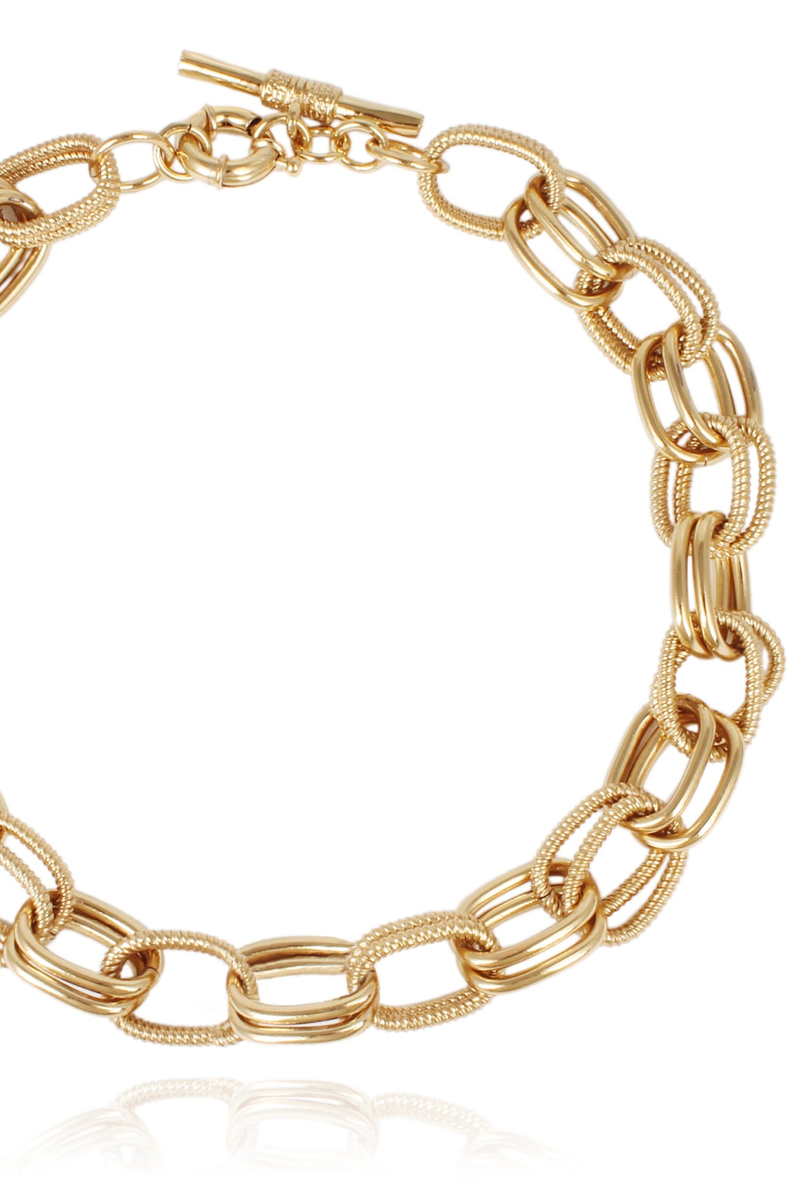 This image features the Bell O Necklace, a stylish piece of jewelry with a robust and luxurious design. The necklace is crafted with interlinked gold-tone chains that boast a polished finish, enhancing their shine and elegance.